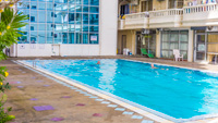 Pattaya condo for rent with large outdoor swimming pool. Simply step out of your apartment to the pool in Nirun Grand Ville.