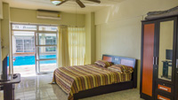 Swimming Pool view, two room condo for rent in Pattaya Thailand. Both, living room and bedroom provide a view of the pool.
